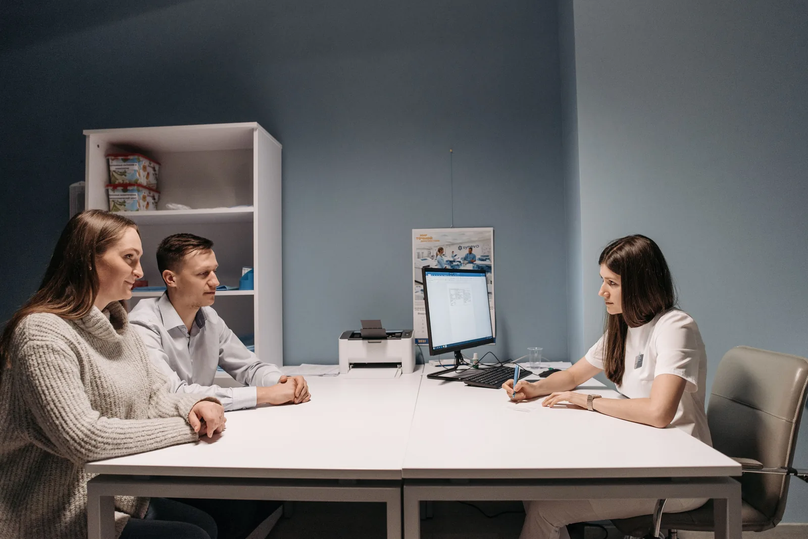 Doctor consulting with a couple in a clinic