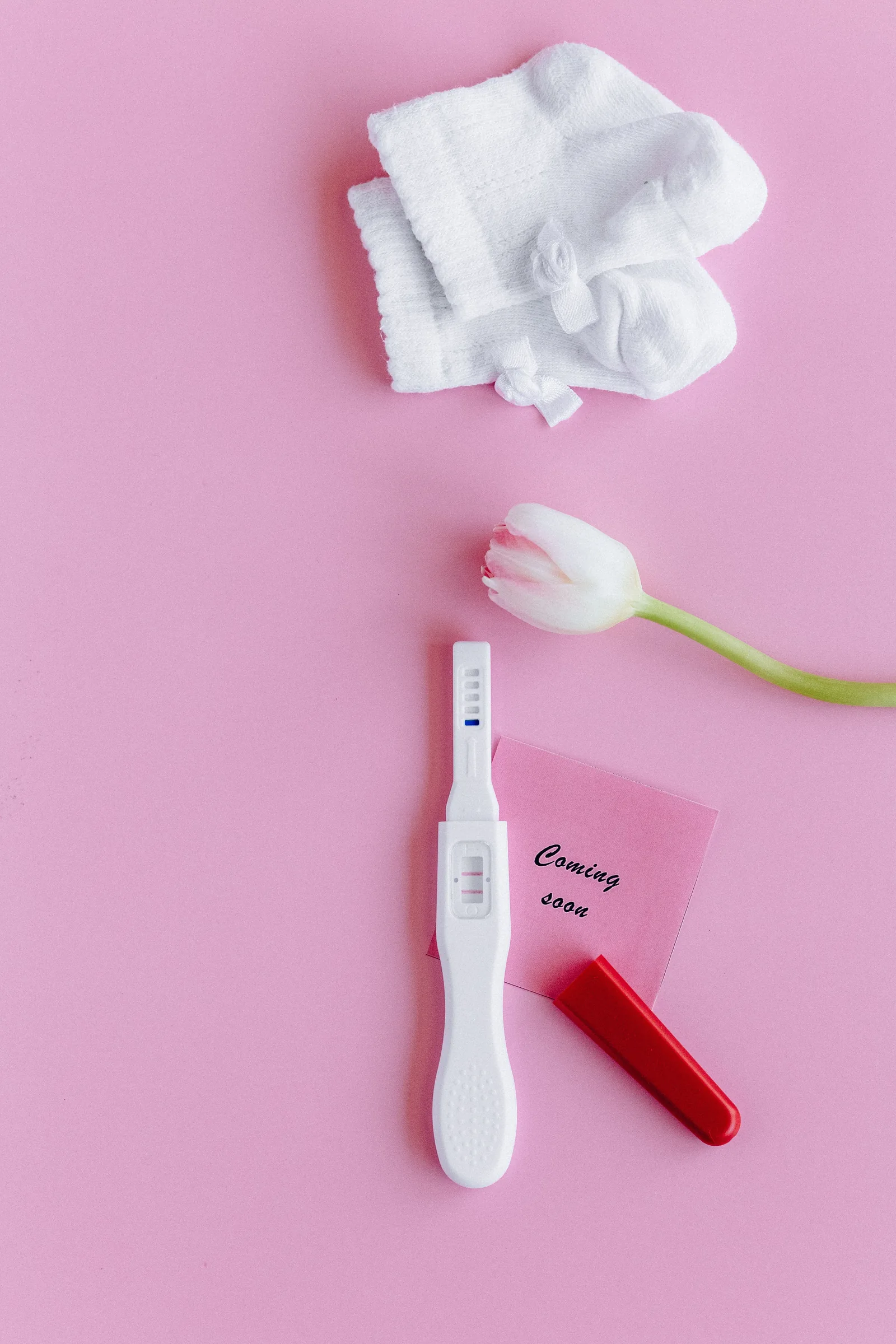 Fertility preservation concept with pregnancy test and baby items